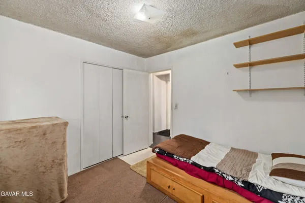 a living room with a bed and furniture
