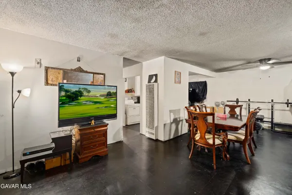 a livingroom with furniture a flat screen tv and floor to ceiling window