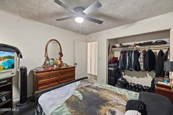 a bed room with a bed and a television