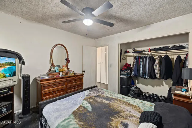 a bedroom with a bed and a flat screen tv