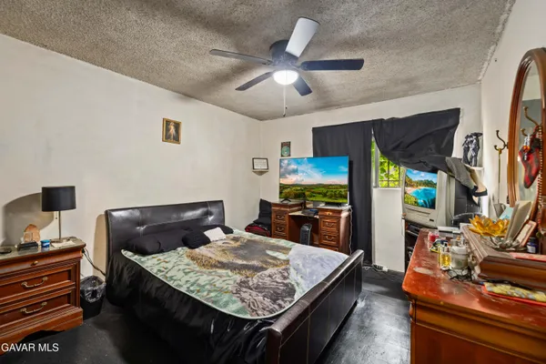 a bedroom with a bed and a flat screen tv