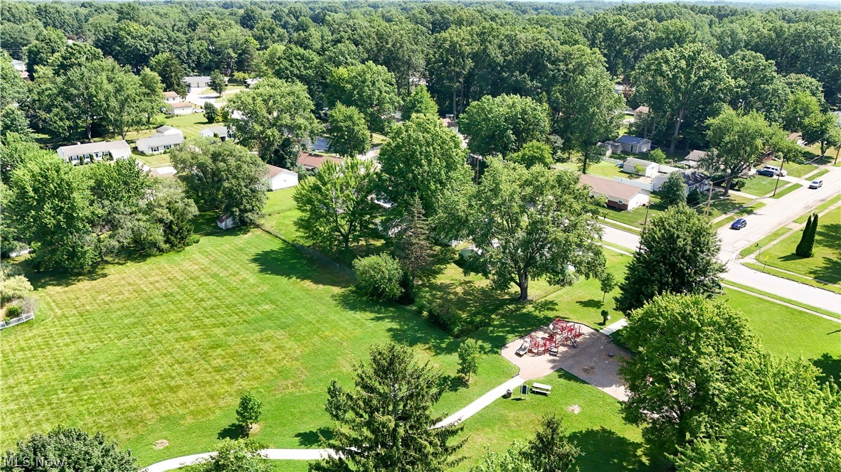 3796 North Santom Road Stow, OH 44224 - Photo 26 of 30 Expansive green space featuring a manicured lawn, established trees, and a dedicated play area