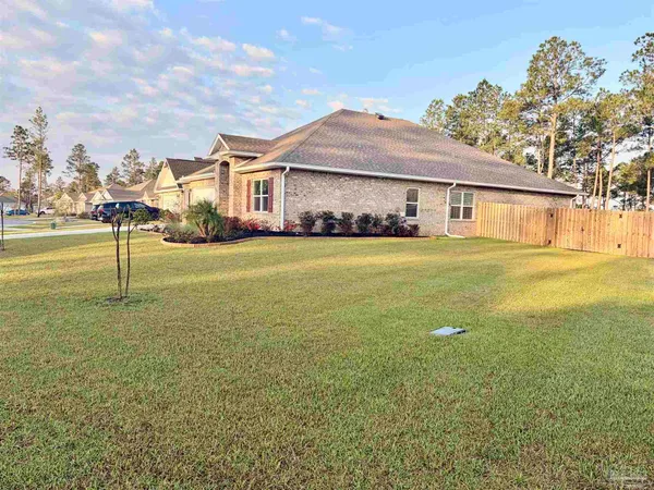 a front view of a house with a garden and yard