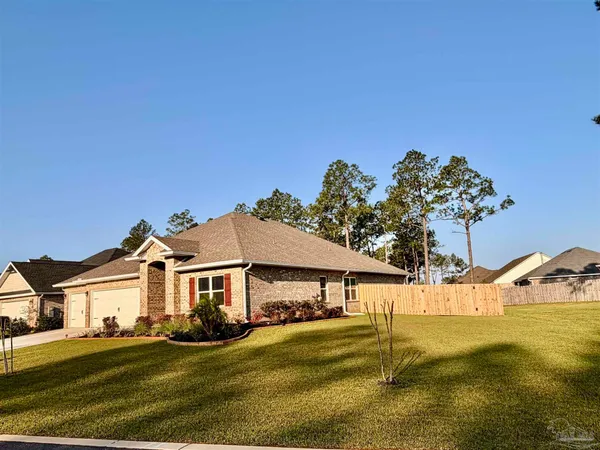 a living room with furniture a flat screen tv and a window