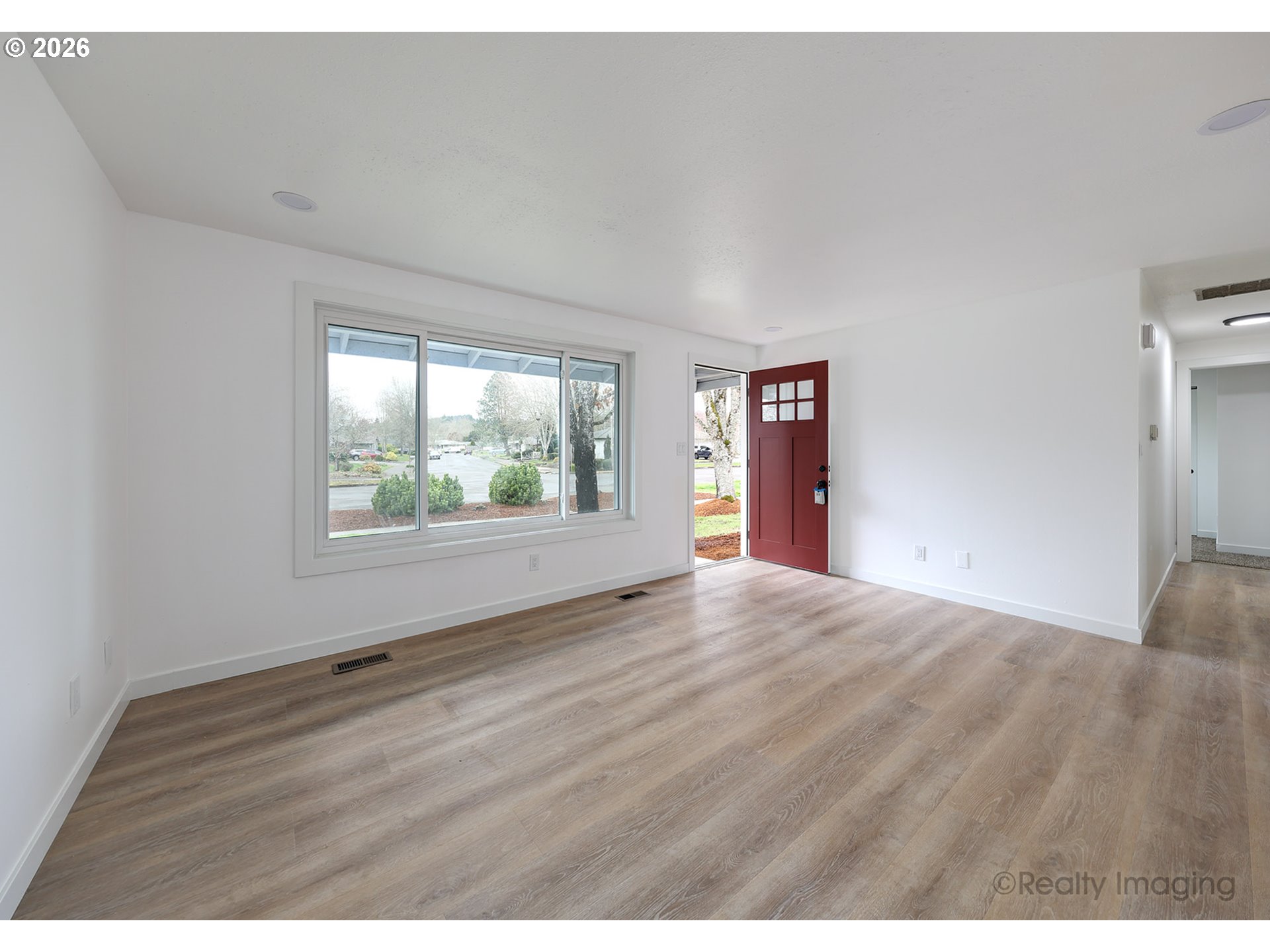 3075 Northeast Lancaster Street Corvallis, OR 97330 - Photo 2 of 13 an empty room with wooden floor and windows