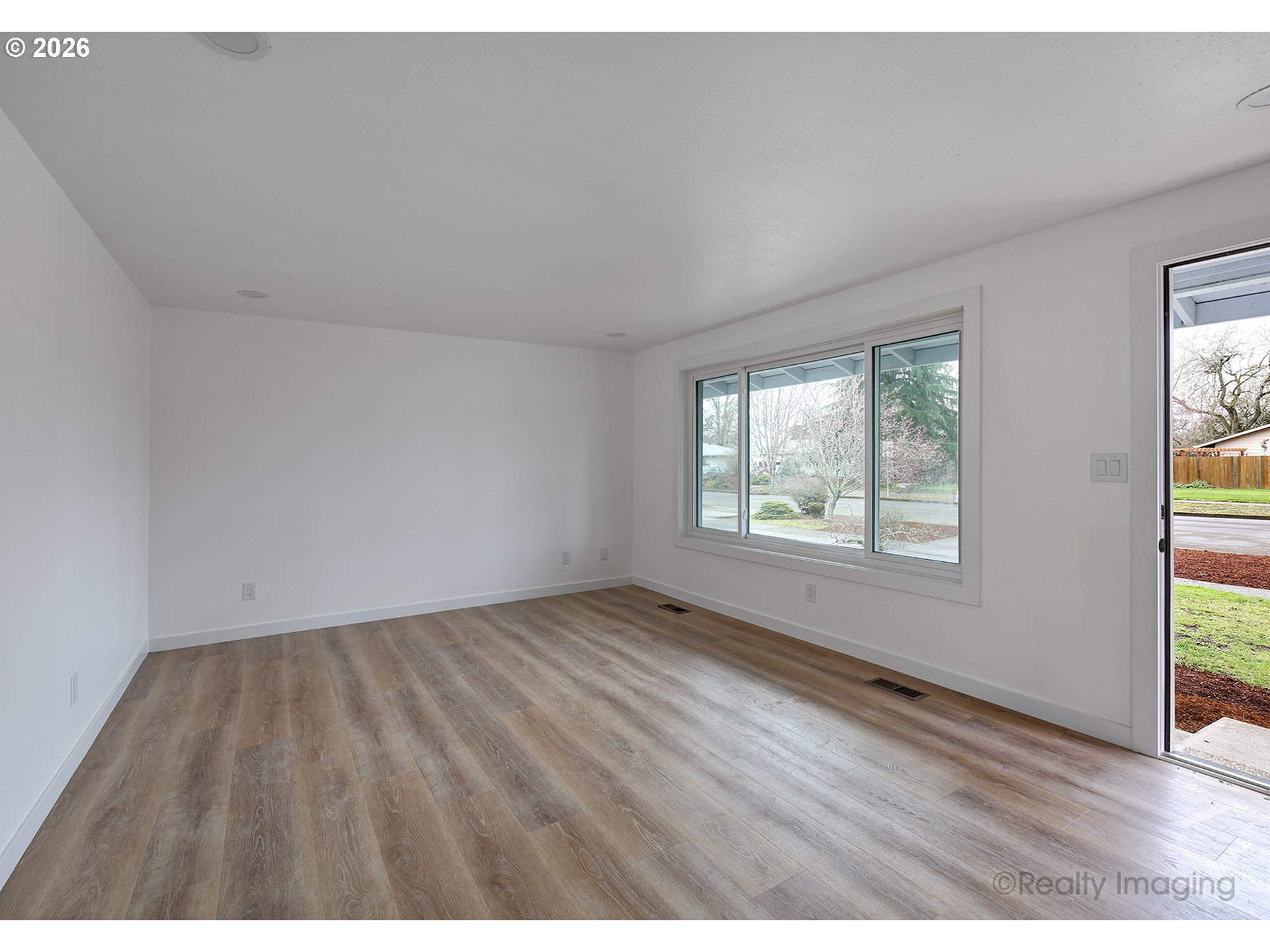 3075 Northeast Lancaster Street Corvallis, OR 97330 - Photo 3 of 13 an empty room with wooden floor and windows
