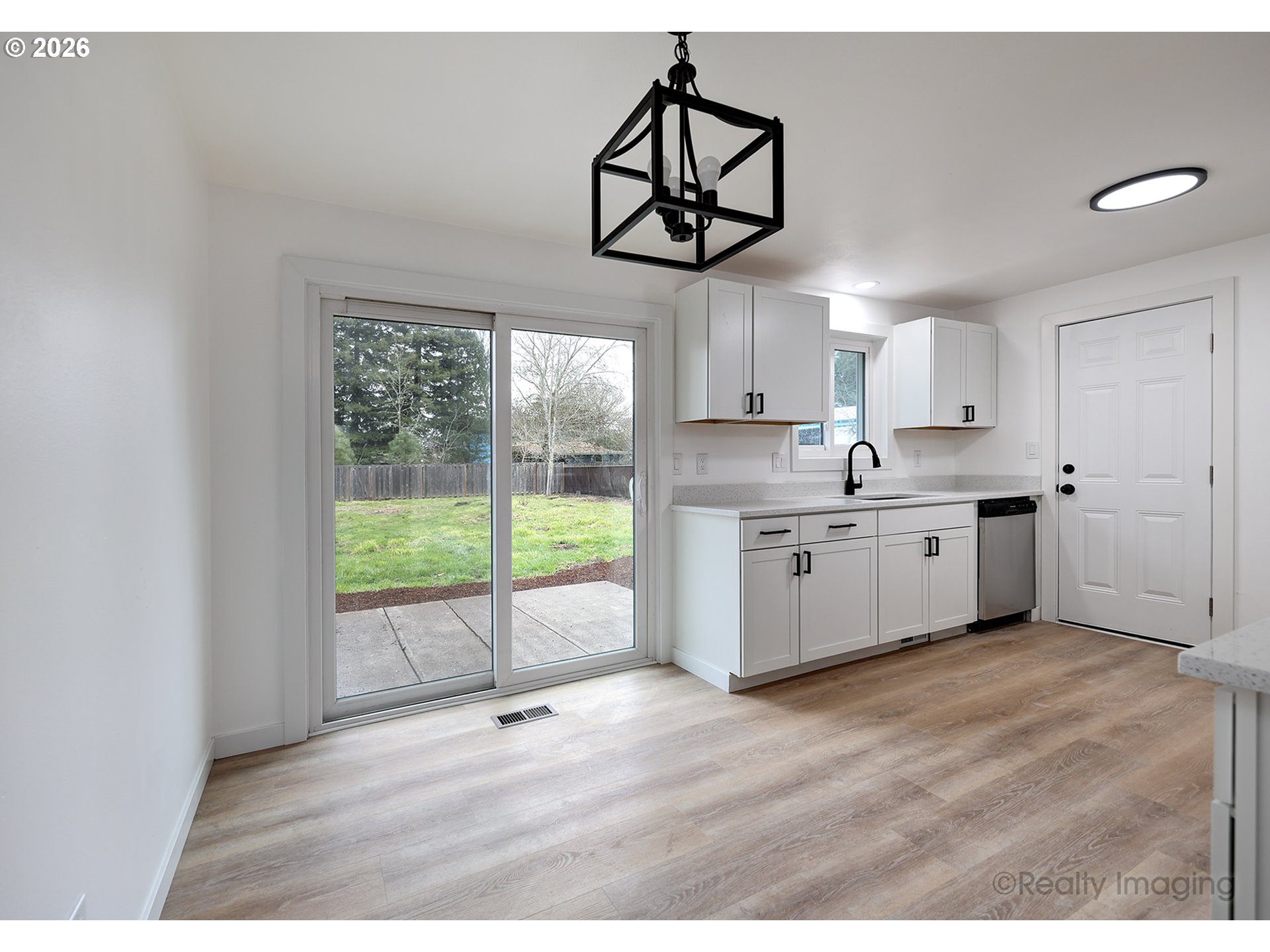 3075 Northeast Lancaster Street Corvallis, OR 97330 - Photo 5 of 13 a kitchen with stainless steel appliances granite countertop a stove a sink and white cabinets with wooden floor