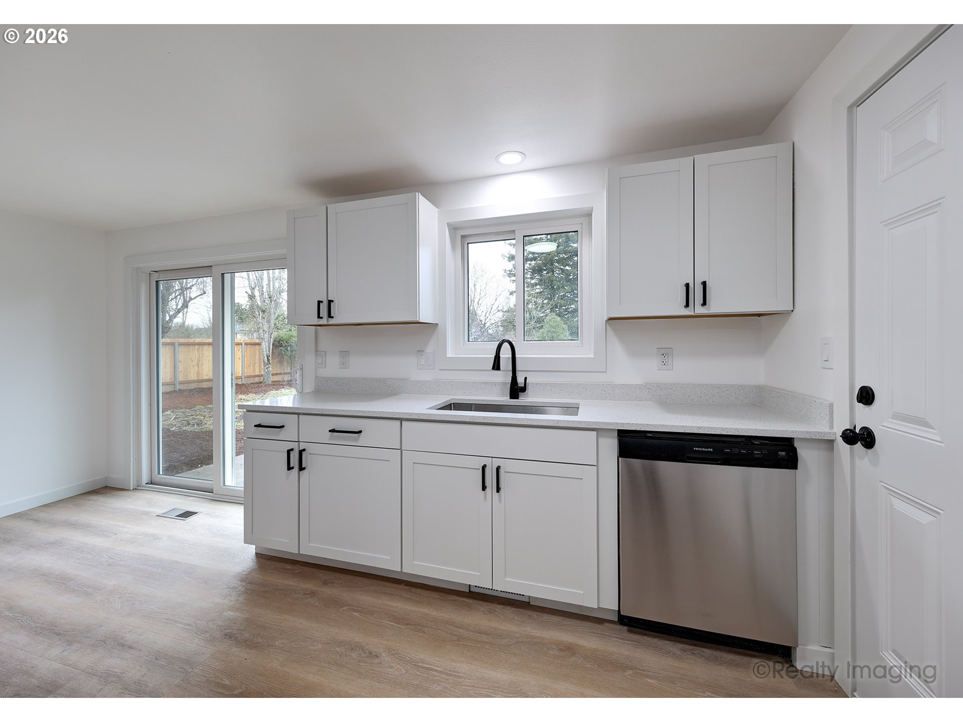 3075 Northeast Lancaster Street Corvallis, OR 97330 - Photo 7 of 13 a kitchen with granite countertop white cabinets sink and window