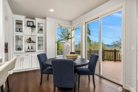 a view of a dining room with furniture large windows and wooden floor