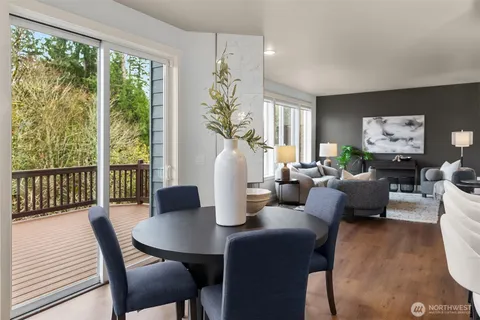 a living room with furniture a large window and a flat screen tv