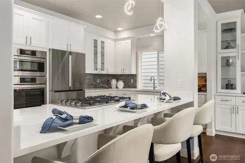 a kitchen with stainless steel appliances a stove a sink and a refrigerator