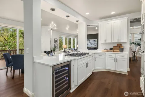 a kitchen with a sink cabinets and wooden floor