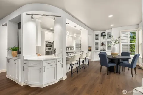a view of a dining room with furniture and wooden floor