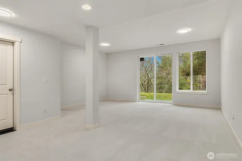 an empty room with windows and closet