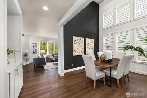 a dining room with furniture and wooden floor