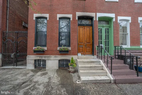 a view of front door of house with stairs