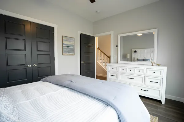 a bedroom with a bed and a large mirror