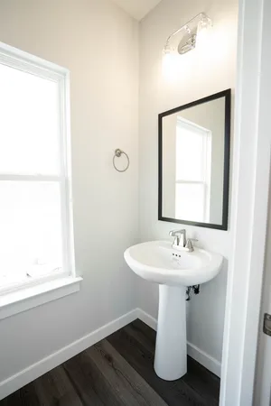 a bathroom with a sink toilet and mirror