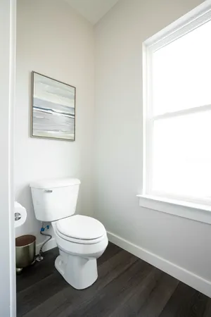 a white toilet sitting next to a bathroom sink