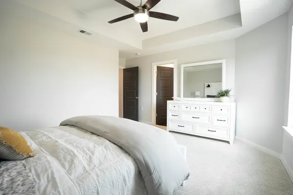 a bedroom with a bed and ceiling fan