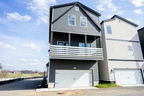 a view of a white house with a roof deck