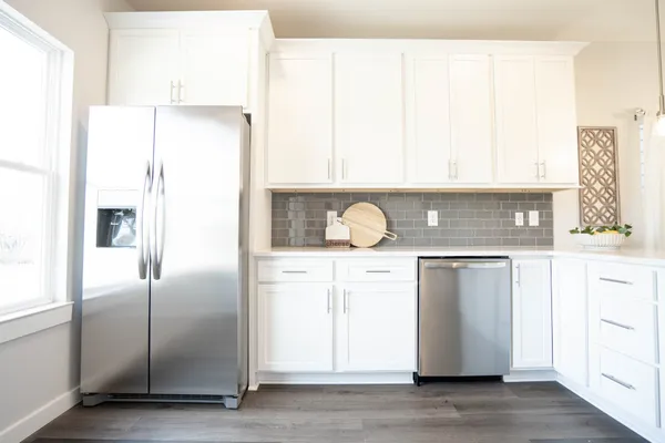 a kitchen with a refrigerator and a stove