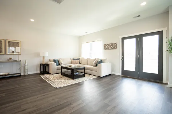 a living room with furniture window and wooden floor