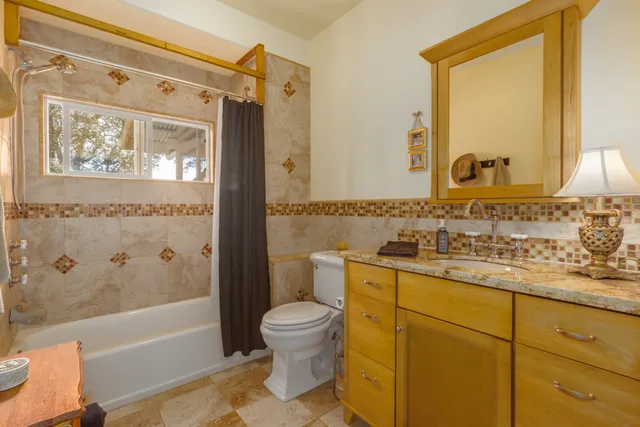 a bedroom with a large bed and a flat tv screen