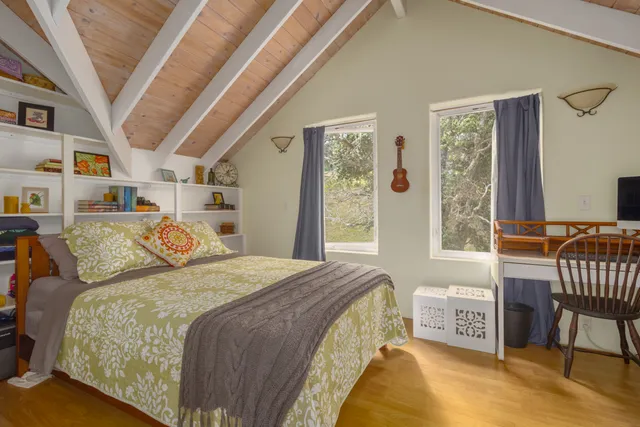 a bedroom with furniture and a window