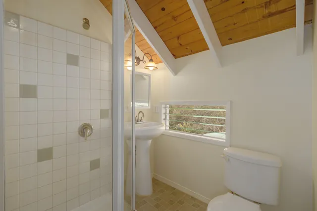 a view of a house with a yard balcony and trees