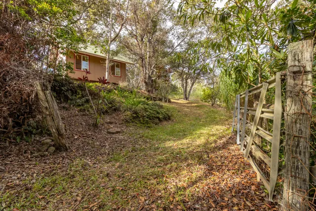 a spacious bedroom with a bed a couch and large window