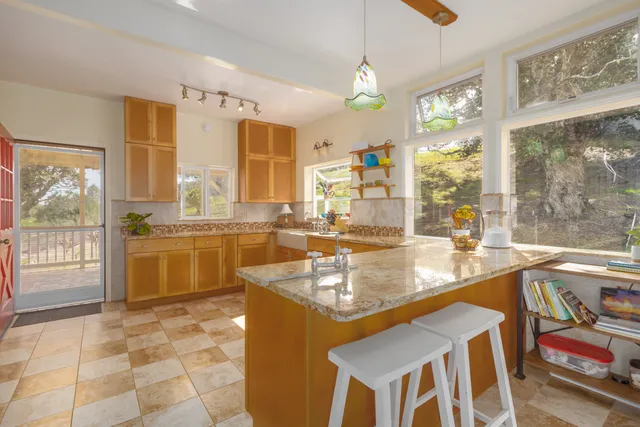 a very nice looking kitchen with a large window cabinets and stainless steel appliances