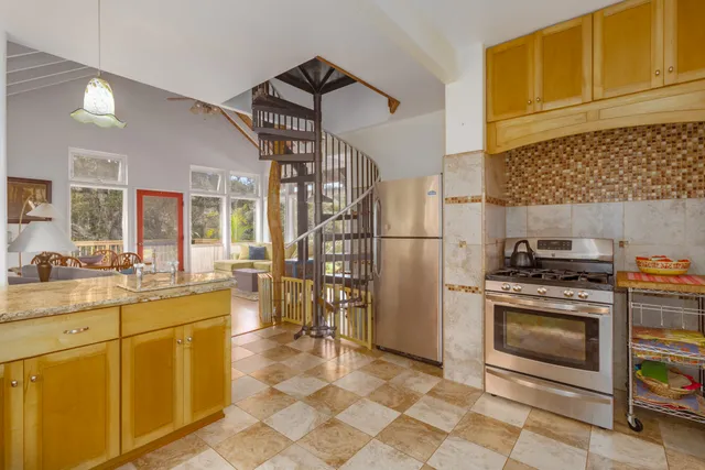 a kitchen with appliances cabinets and a stove top oven