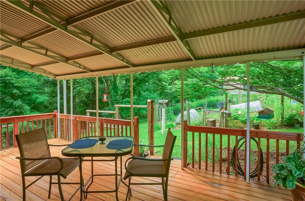 836 Harmony Road Pittsburgh, PA 15237 - Photo 5 of 46 a view of a patio with table and chairs with wooden floor to ceiling window and wooden fence