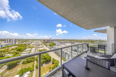 a view of a balcony with wooden chairs