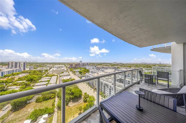 a view of a balcony with wooden chairs