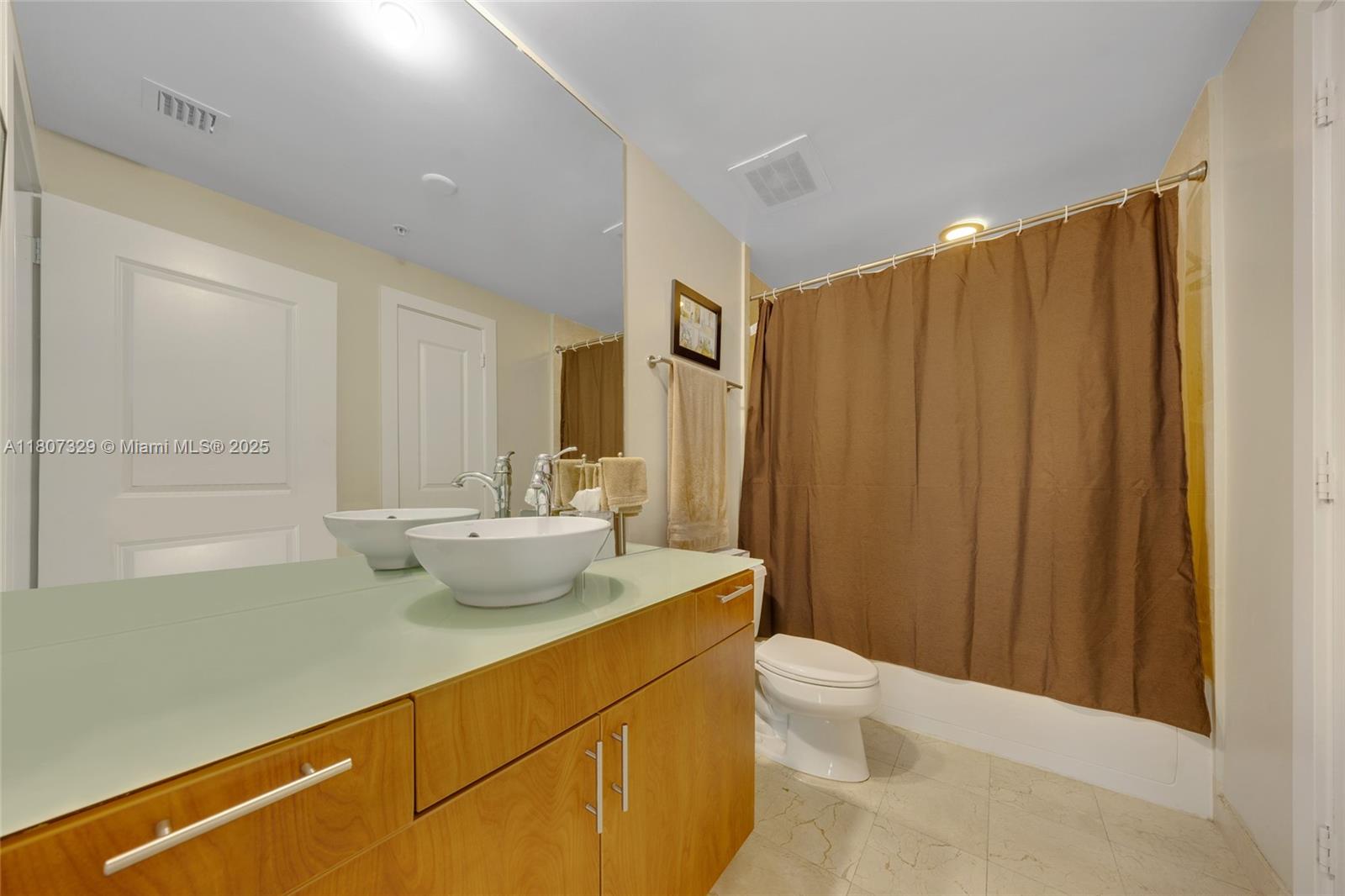 315 Northeast 3rd Avenue, Unit 1809 Fort Lauderdale, FL 33301 - Photo 19 of 32 a bathroom with a sink a toilet and shower