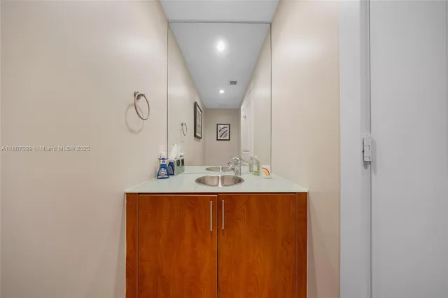 a bathroom with a sink a mirror and vanity