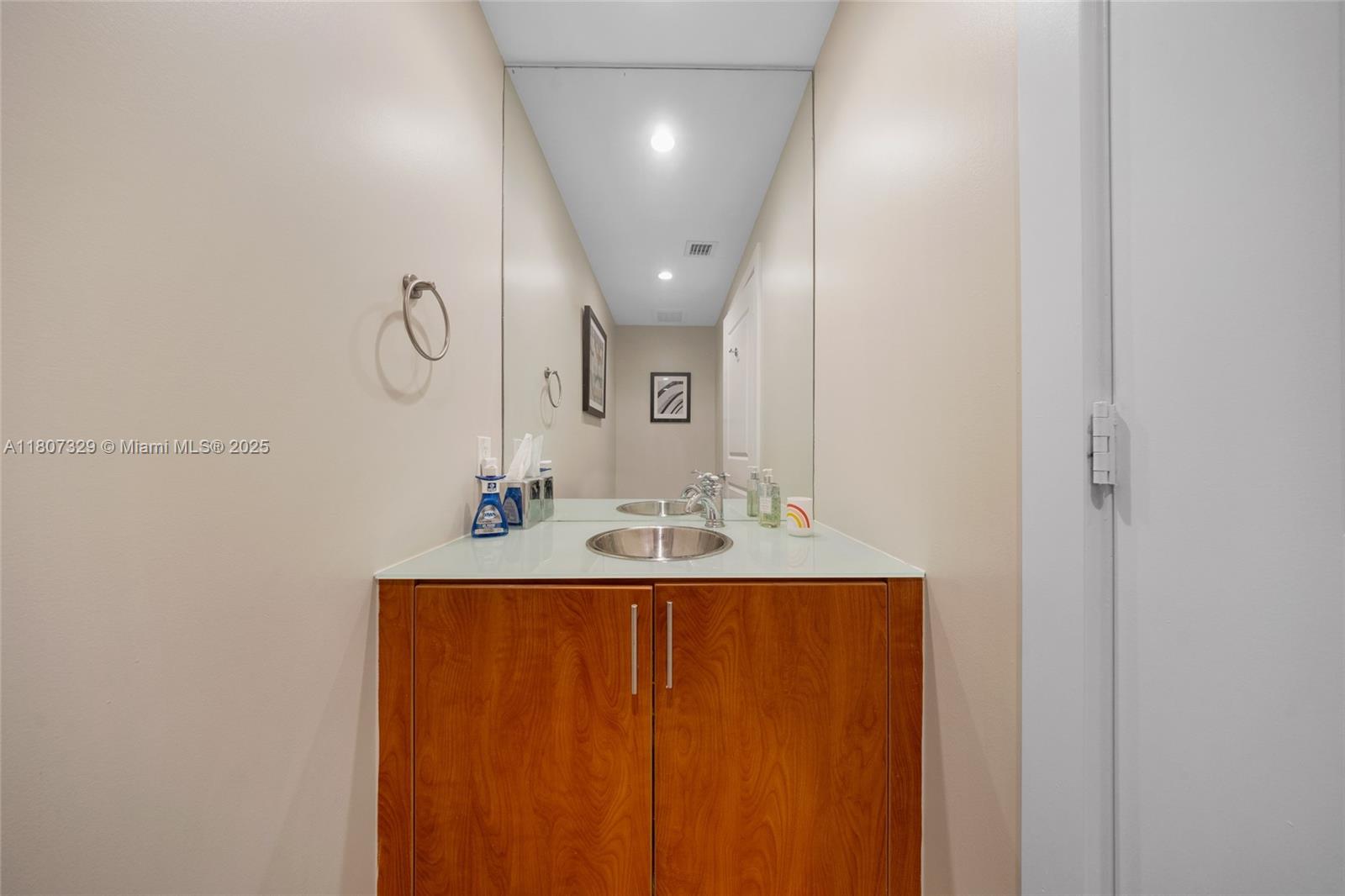 315 Northeast 3rd Avenue, Unit 1809 Fort Lauderdale, FL 33301 - Photo 21 of 32 a bathroom with a sink a mirror and vanity