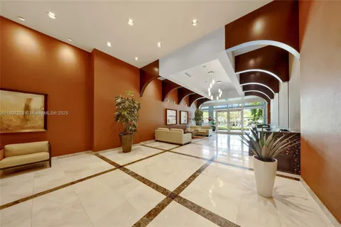 a living room with furniture and floor to ceiling window