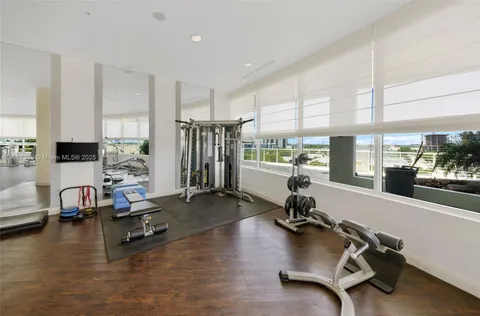a room with gym equipment and a large window