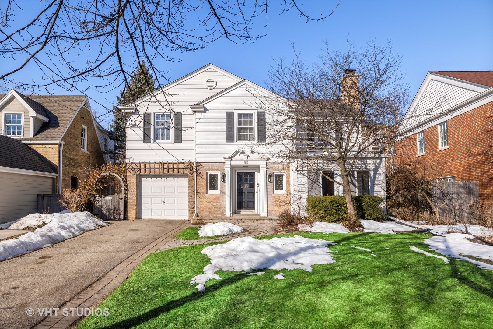 82 Warwick Road Winnetka, IL 60093 - Photo 1 of 23 a front view of a house with a yard