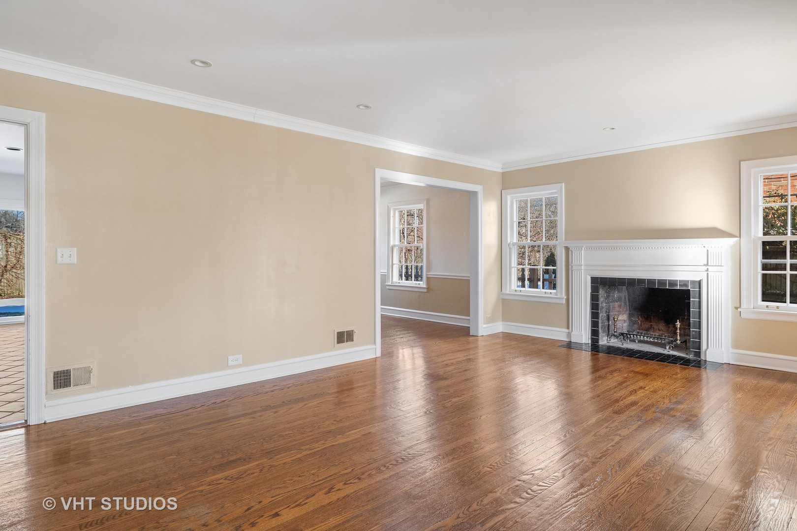 82 Warwick Road Winnetka, IL 60093 - Photo 2 of 23 an empty room with wooden floor and fireplace