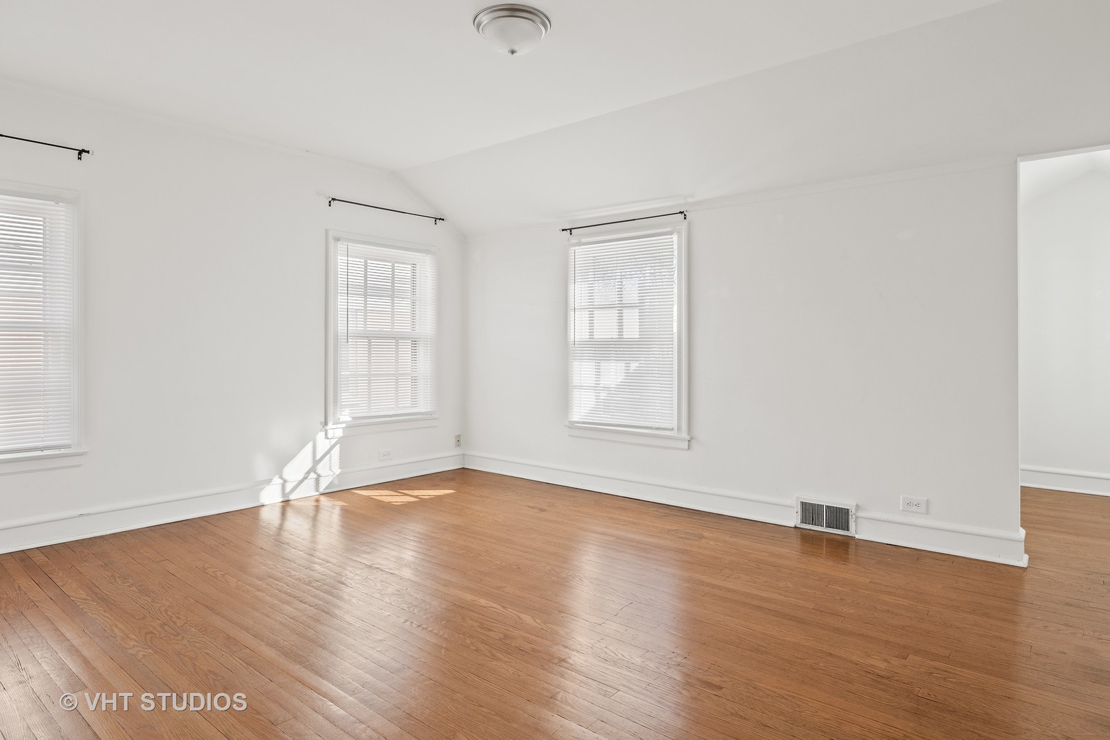 82 Warwick Road Winnetka, IL 60093 - Photo 17 of 23 an empty room with wooden floor and windows