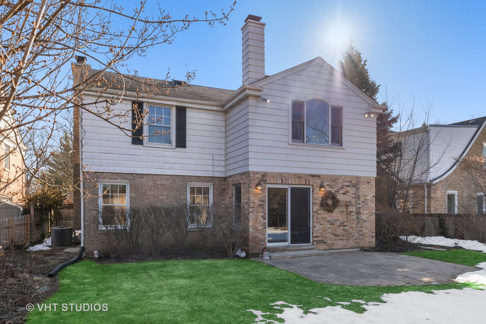 82 Warwick Road Winnetka, IL 60093 - Photo 23 of 23 a brick house with a yard plants and large trees