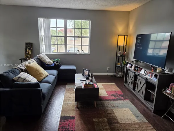 a living room with furniture and a rug