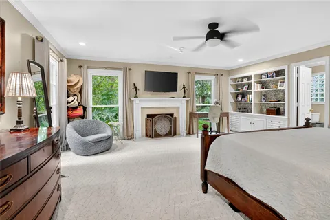 a bedroom with furniture and a fireplace