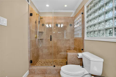a bathroom with a toilet and a shower