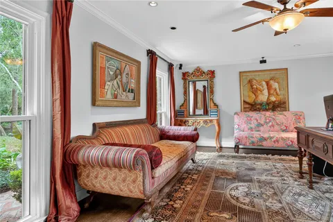 a dining room with furniture a window and wooden floor