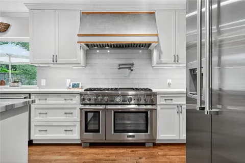 a kitchen with a sink cabinets and window